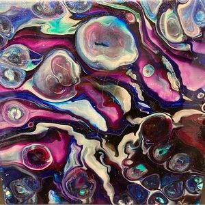 Three of my pour paintings.  They turned out awesome looking. One of a kind